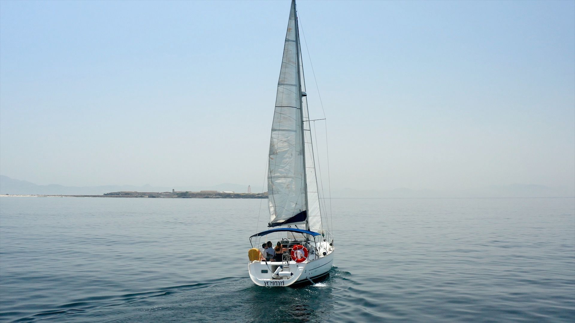 The sailboat bow-on under full sail off Isla de Tarifa